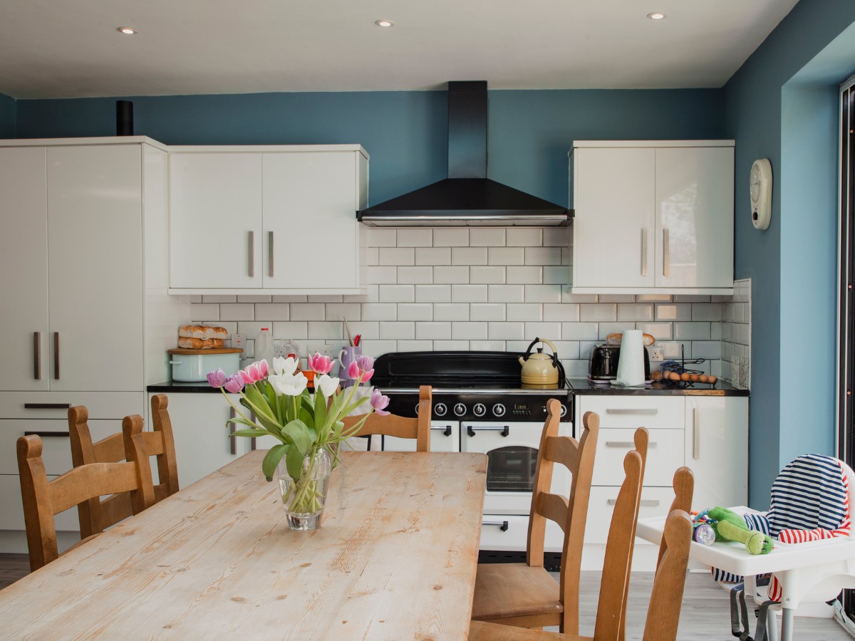 A modern kitchen with a dining table in foreground